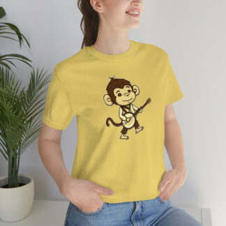 A woman wearing a yellow banjo shirt with a cute, brown cartoon monkey holding a banjo while walking.