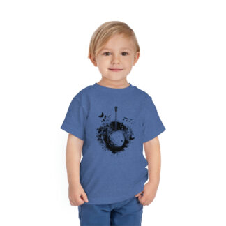A little boy wearing a blue banjo shirt with an abstract black-and-white design of a banjo surrounded by musical notes, birds, and other nature designs.