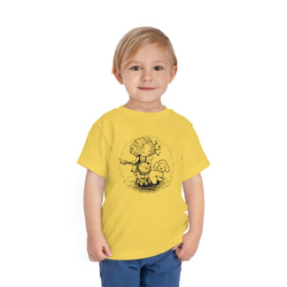 A little boy wearing a yellow shirt with a sketch of girl sitting on a chair playing the banjo for her white dog (maybe a bichon frise or a poodle). She is radiating musical notes and surrounded by a cloud-like frame.